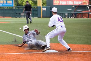 Junior Tanner Boyzuick slides into the third beating the ball to Tyler Henson in the 9-4 win over Abilene Wylie. (Caleb Miles/Special Contributor)