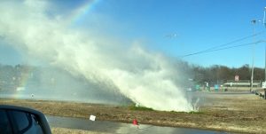 A resident snaps a photo of the water main break off Morriss Road at Garden Road. 