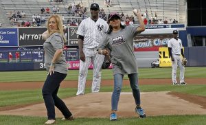 Debbie Sardone, (left) founder of Cleaning for a Reason, throws out the first pitch at a New York Yankees baseball game on June 7. Sardone is pictured with Marybell Ruiz, a cancer patient and mother of two.
