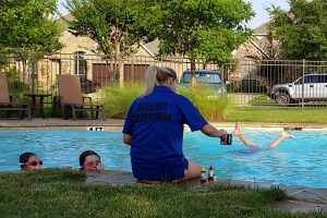 A Lantana pool monitor checks chlorine levels at the Heritage neighborhood pool in Lantana.